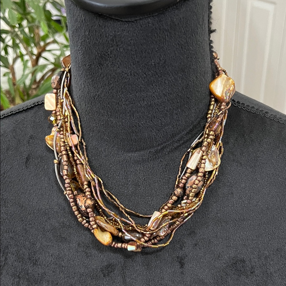 Multi strand necklace featuring abalone and brown, copper, amber beads